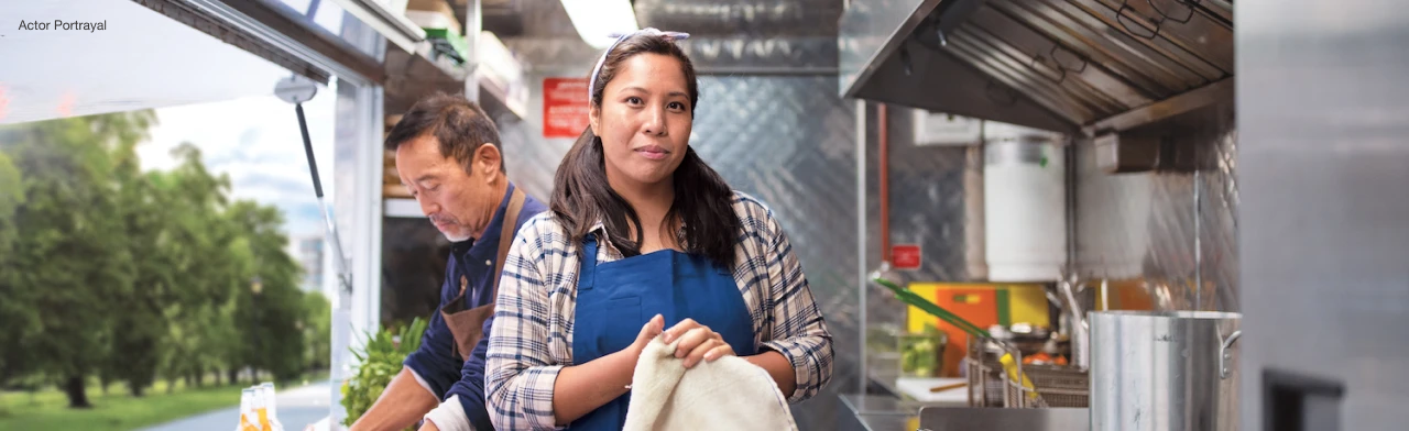 Woman and man working on a food truck